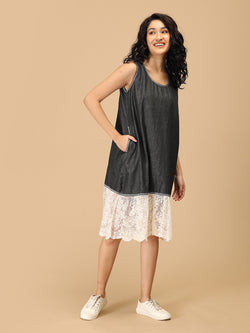 Dark chambray sleeveless dress with scalloped lace hem — front pose for women’s casual wear.